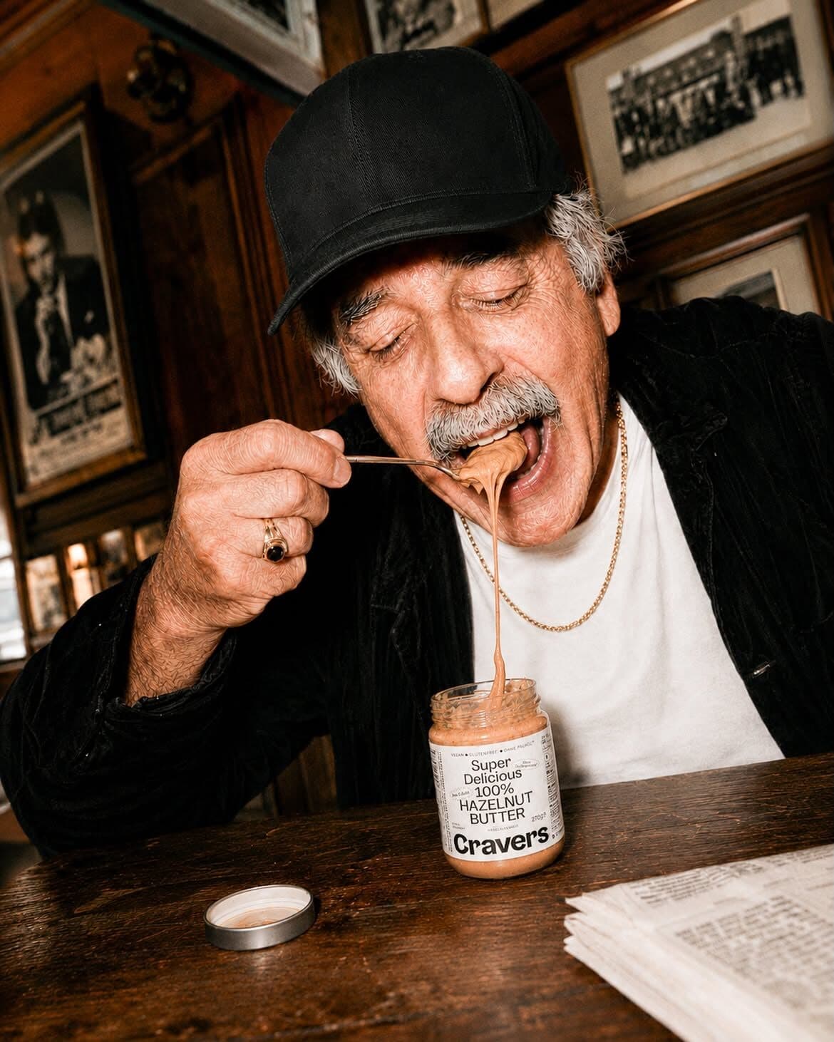 Man tasting Cravers spread at a café table