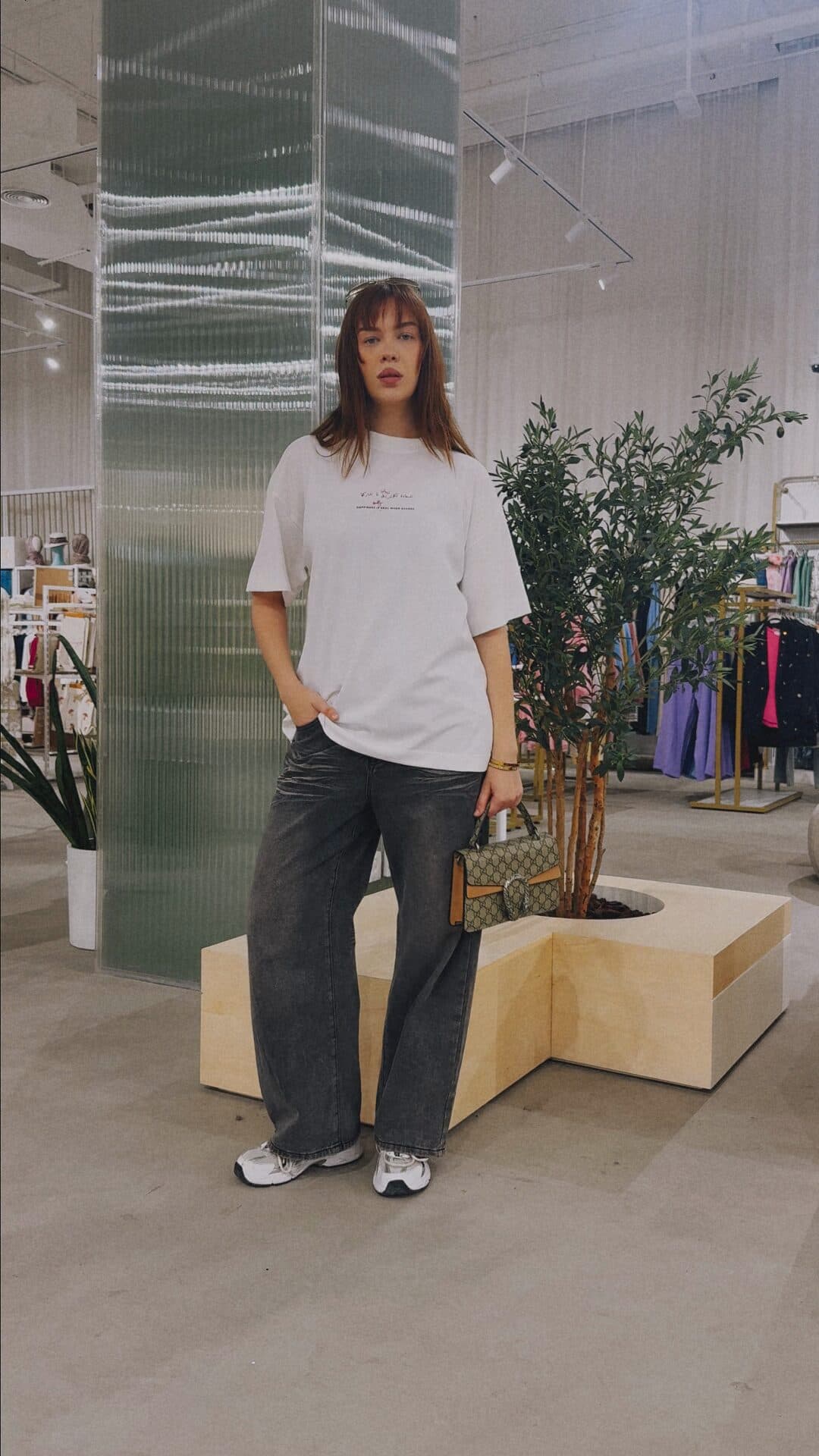 Man in a white tee in a store, from Terribly Real’s Feel Good T-shirt video